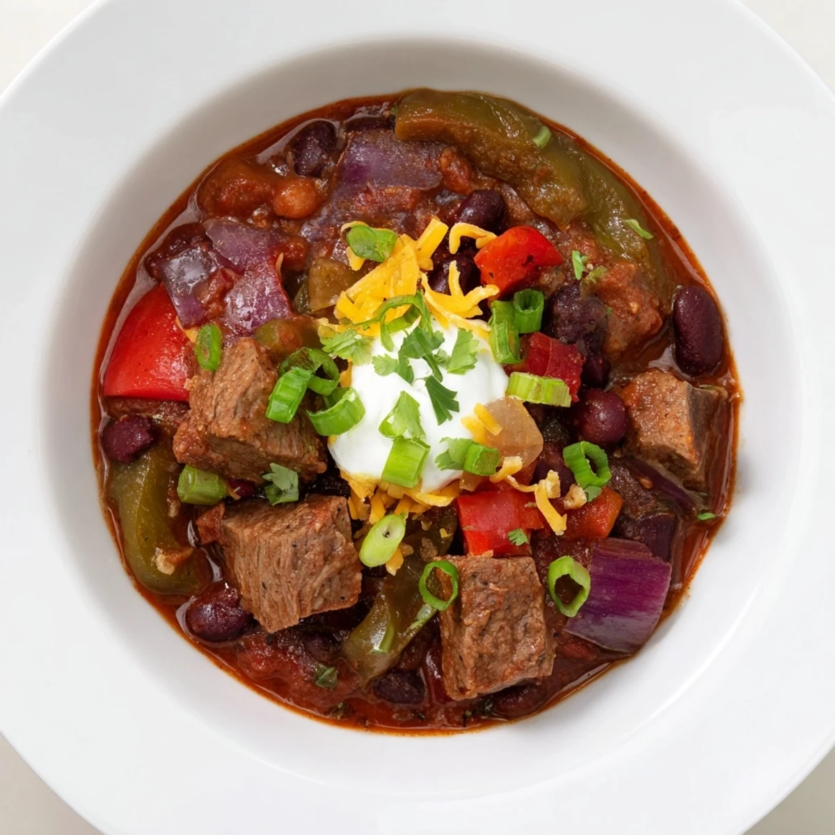 Steaming Winter Warming Chili con Carne, with rich brown beef and colorful bell peppers on display.