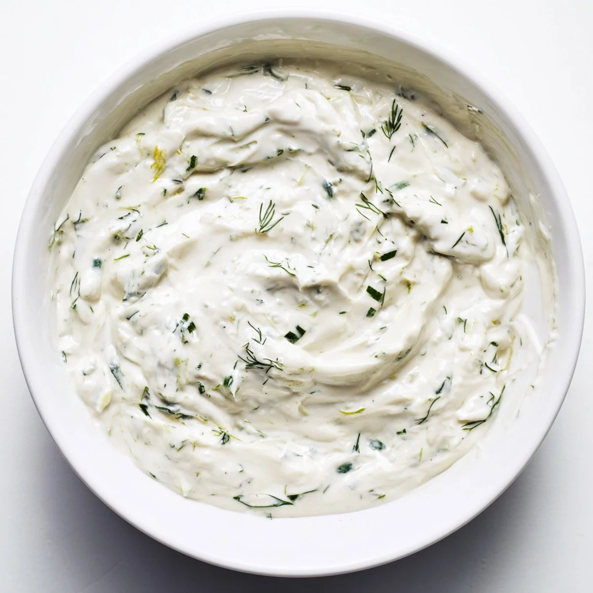 Creamy Greek yogurt ranch dip, studded with fresh herbs, ready for dipping vegetables or chips.