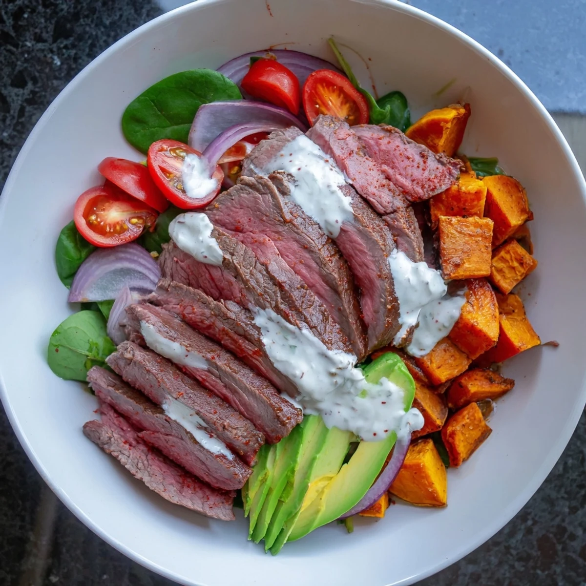 Beef Avocado Sweet Potato Bowl with tender beef, creamy avocado, and roasted sweet potatoes in bowls.
