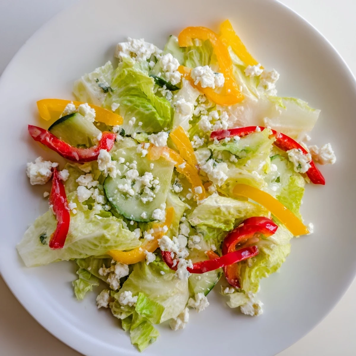 Vibrant Bella Hadid Salad: Crunchy romaine, colorful peppers, and creamy feta, drizzled with zesty lemon vinaigrette.