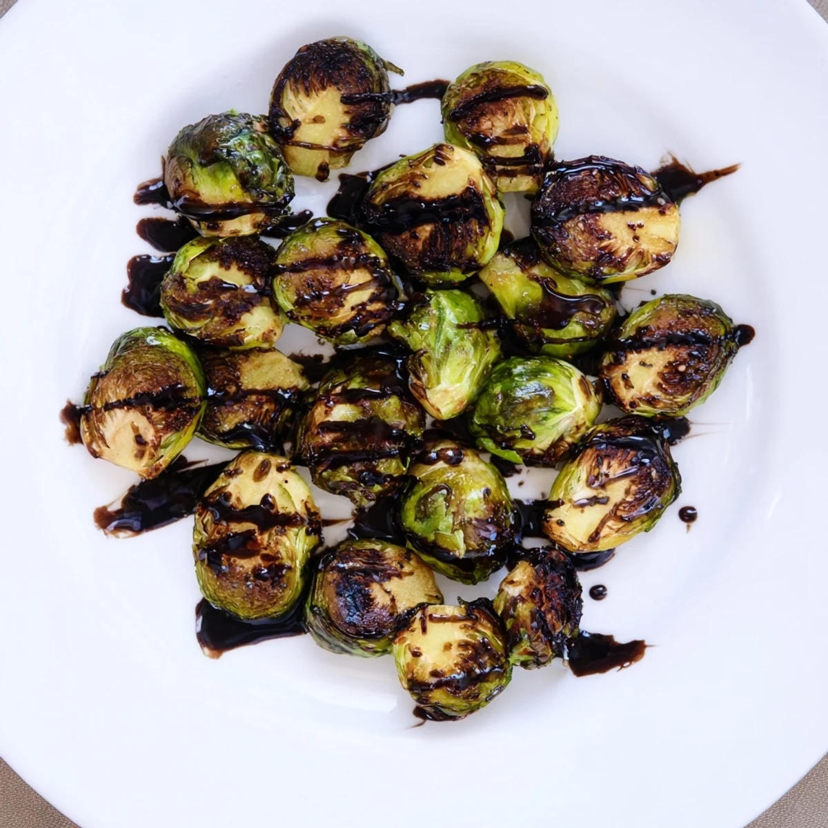 Caramelized Brussels sprouts roasted to perfection and drizzled with tangy balsamic reduction for a savory side.