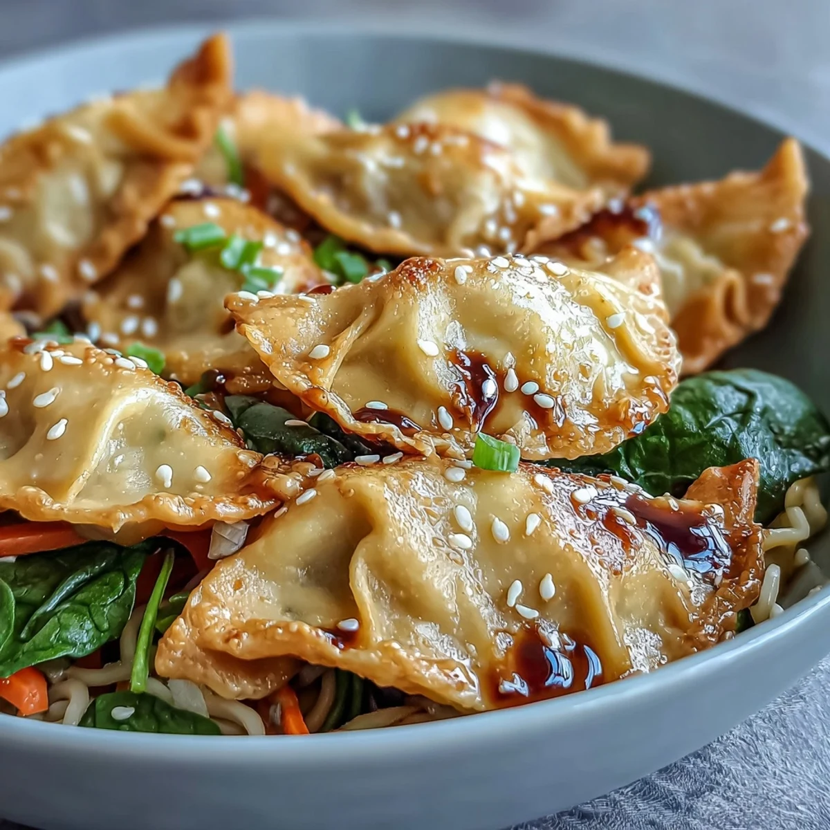 Garnished with green onions, this easy Potsticker Noodle Bowls recipe is served steaming hot in a ceramic bowl.
