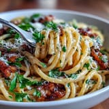 Bright lemon butter pasta with peas and Parmesan, topped with fresh parsley for a springtime dinner.  