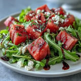 Enjoy this fresh Watermelon Feta Arugula Salad, piled high in a bowl.