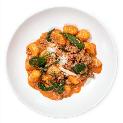 Image of Creamy Tomato and Sausage Gnocchi: a rustic bowl brimming with cheesy, saucy pasta and sausage.