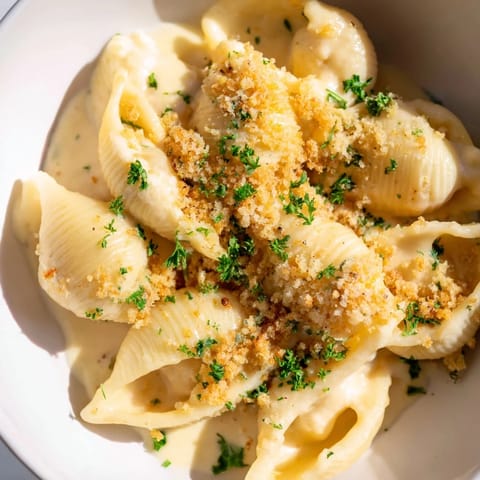A steaming bowl of high-protein mac & cheese, texturized with breadcrumbs, ready to eat.