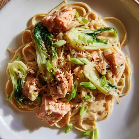 A close-up of steaming Miso Butter Salmon Pasta: rich, umami flavors with tender salmon and bok choy.