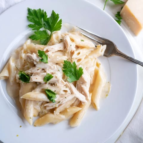 Roasted Garlic Chicken Penne with tender chicken, silky cream sauce, and fresh parsley garnish.  