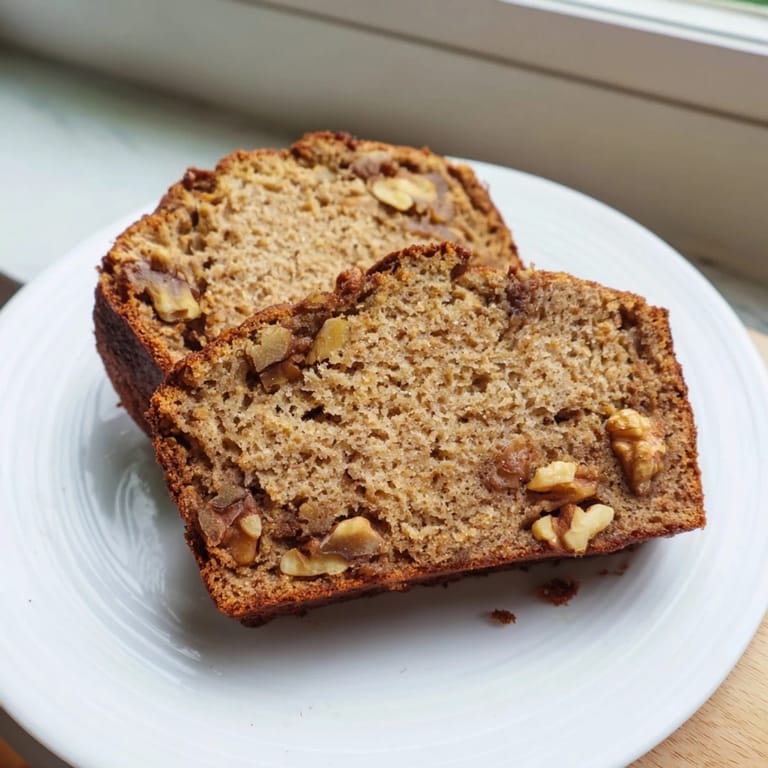 Moist Simple Banana Bread, speckled with banana and golden crust, perfect for breakfast or dessert.