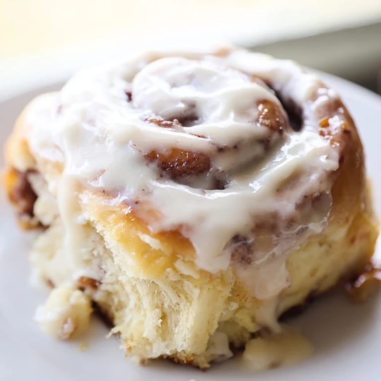 Pulling apart a gooey Pillow Soft Cinnamon Roll reveals fluffy layers of brown sugar and cinnamon spice.