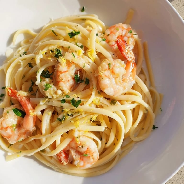 A close-up of savory Garlic Butter Shrimp Linguine tossed with minced garlic and red pepper flakes for a spicy kick.
